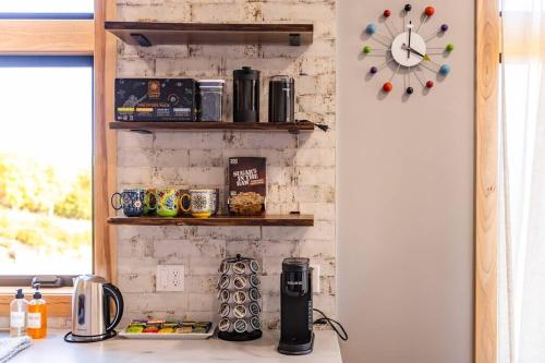 a kitchen with a counter and a clock on a wall at Inlet View Home in Homer