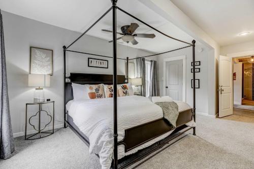 a bedroom with a black canopy bed in a room at Bristhol Bloom! Oasis in the Heart of COS! in Colorado Springs