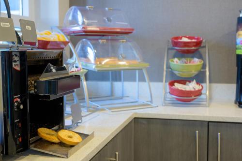 a kitchen with a counter with some food and bowls at Hawthorn Extended Stay by Wyndham Panama City Beach in Panama City Beach