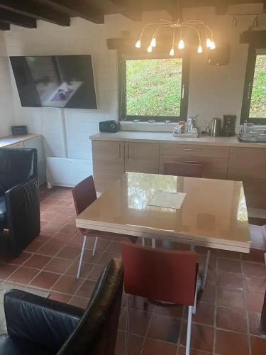 a kitchen with a table and some chairs and a table at dar zaina in Blaimont