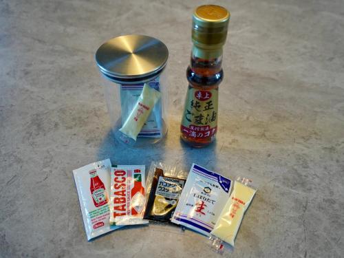 a group of food items on a table with a jar of sauce at ALFACIO RESORT STAY ITOSHIMA in Itoshima