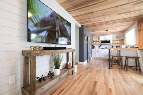 a kitchen with a large tv on the wall at Hometown Haven- 3 bedroom, Large Yard, Firepit in Ames