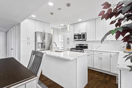 a white kitchen with a sink and a refrigerator at Stunning home in Skokie in Skokie