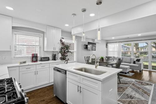 a kitchen with a sink and a living room at Stunning home in Skokie in Skokie