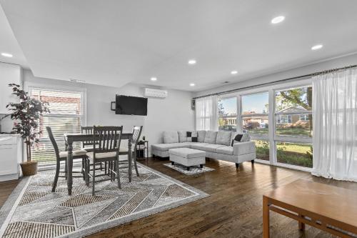 a living room with a table and chairs and a couch at Stunning home in Skokie in Skokie