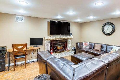 a living room with a leather couch and a fireplace at Private Hot Tub on 10 Acres Cozy Catskill Getaway in Catskill
