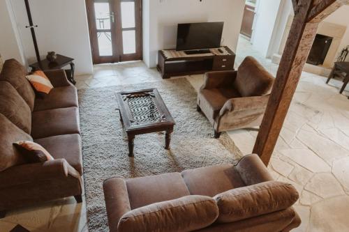 a view of a living room with couches and a table at Ariadni Cottage in Vasa