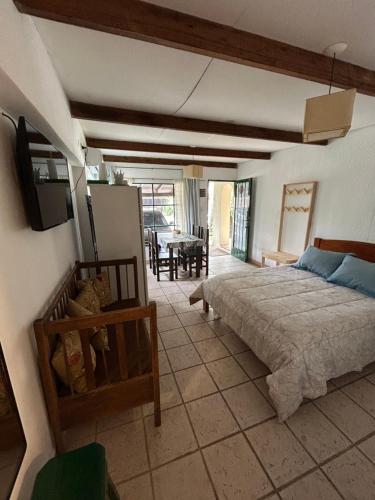 a bedroom with a bed and a living room at El Cuartito in Federación