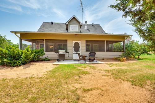 a house with a table and chairs in front of it at half Mi to Lake Texoma Home with Fire Pit and Grill! in Kingston