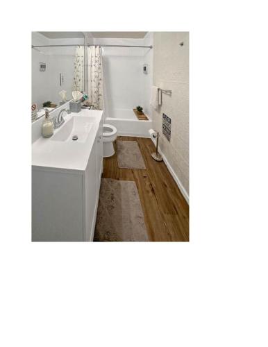 a bathroom with a white sink and a toilet at Miami Suite Life in Tamiami