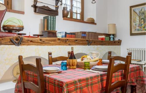 a table with a table cloth and a bottle of wine at 3 Bedroom Stunning Home In Uzzano Pt in Uzzano