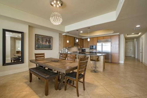 a kitchen and dining room with a wooden table and chairs at Turquoise Place C2202 in Orange Beach