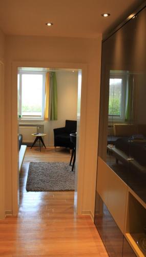 a living room with a couch and a table at Strandhotel Achtert Diek in Langeoog