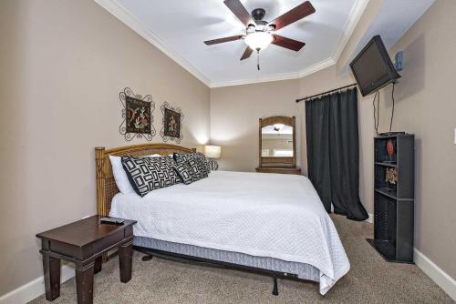 a bedroom with a bed and a ceiling fan at Phoenix on the Bay II 2212 in Orange Beach