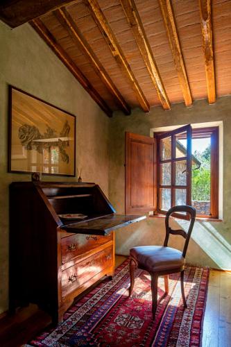 a chair in a room with a desk and a window at Villa Experience - Relais Il Termine Elba in Rio Marina