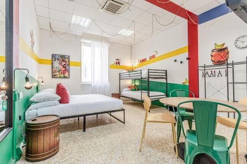 a bedroom with two beds and a table and chairs at Game Rooms Experience in Livorno