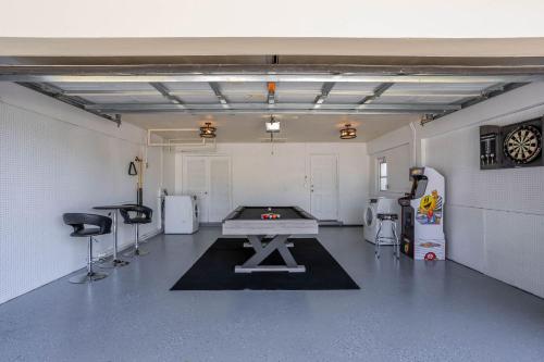 a garage with a ping pong table in it at 3BR HEATED POOL CLOSE TO BEACH in Boynton Beach