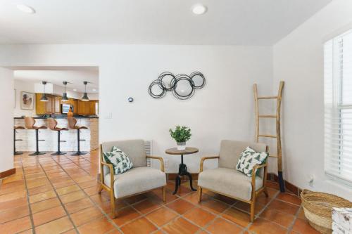 a living room with two chairs and olympic rings on the wall at 3BR HEATED POOL CLOSE TO BEACH in Boynton Beach