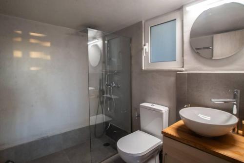 a bathroom with a toilet and a sink and a shower at The Condo Spacious terrace Acropolis Views in Athens