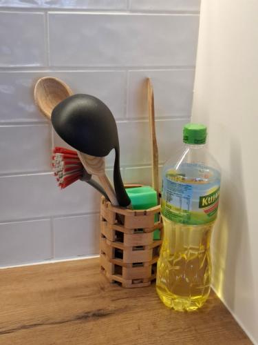 a bottle of oil and a bird toy next to a bottle at ŁADNE MIESZKANIE W PRZYJAZNEJ OKOLICY - NICE APARTMENT IN a FRIENDLY NEIGHBORHOOD in Suwałki