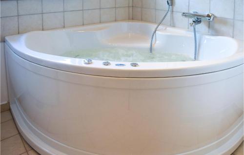 a bath tub filled with water in a bathroom at Holiday Home Klitengene Xi in Thorsminde