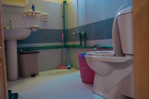 a bathroom with a toilet and a sink at Rumi's House in Gircha