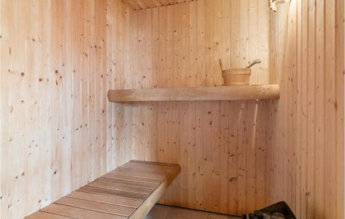 a sauna with a wooden shelf and a wooden bench at Holiday Home Sivsangervej Ebeltoft Iii in Øksenmølle