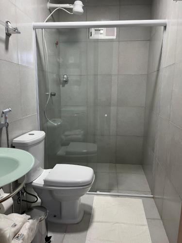 a bathroom with a shower and a toilet and a sink at Tamandaré Divers Resort in Tamandaré