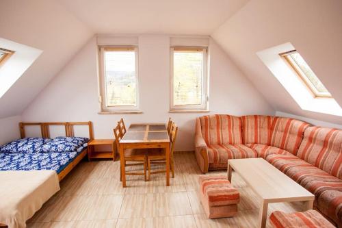a room with a bed a couch and a table at Halinówka - Twoje Miejsce w Górach Sowich in Pieszyce