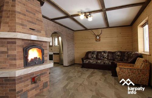 a living room with a couch and a fireplace at Синевирський Краєвид in Synevyr