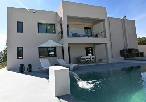 a house with a swimming pool in front of a house at Villa De An in Zakynthos Town