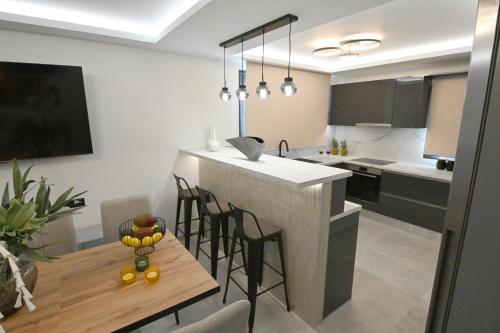 a kitchen with a table and some chairs in a kitchen at Villa De An in Zakynthos Town