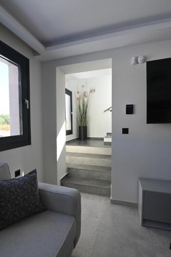 a living room with a couch and a television at Villa De An in Zakynthos Town