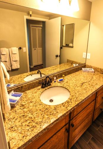 a bathroom with a sink and a large mirror at Skiers Lodge in Park City