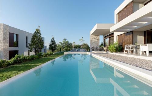 a swimming pool in front of a house at Villa Adoral in Labin