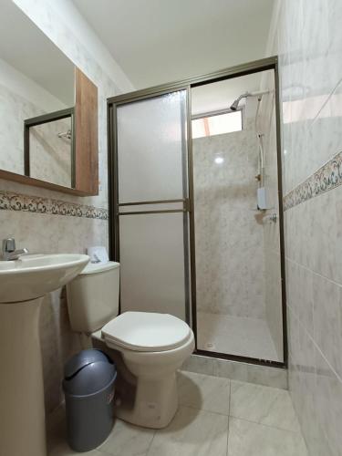 a bathroom with a shower and a toilet and a sink at HOTEL CAMPESTRE CARRIEL QUINDIO picnic in Montenegro