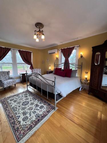 a bedroom with a bed and a rug at The Mulburn Inn in Bethlehem