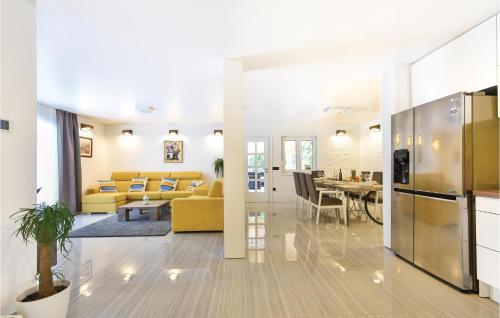 a living room with a yellow couch and a table at Beautiful Home In Omis With Sauna in Omiš