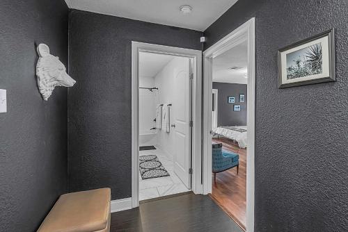 a room with a door leading to a bathroom at New-The Mod Poppy Large home 10 minutes from it all in Waco