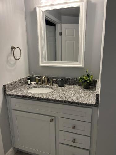 a bathroom with a sink and a mirror at Ocean Walk Resort - Striking Ocean Front View in Daytona Beach