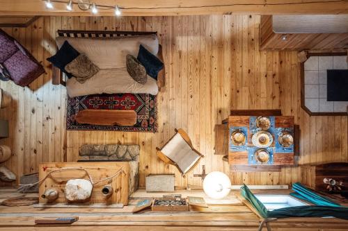 a bedroom with a bed in a wooden wall at Gorgeous Log Cabin - Wineries, Dan River, Hiking in Meadows of Dan