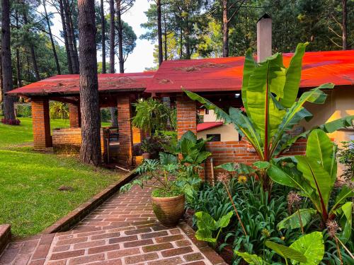 a house with a red roof and a brick walkway at Cabañas Las Morenas Mazamitla in Mazamitla
