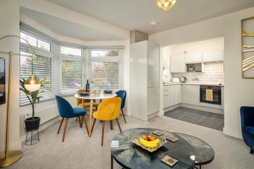 a kitchen and living room with a table and chairs at Coppergate Mews Doncaster Apartment 4 in Doncaster