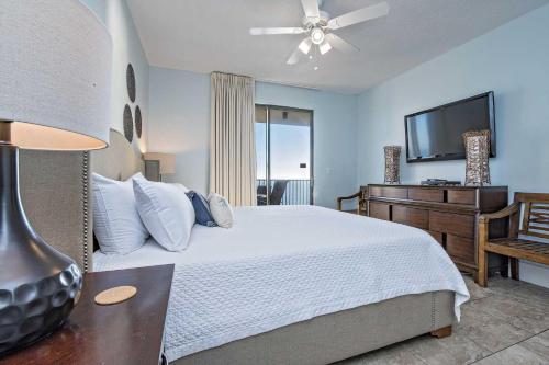 a bedroom with a bed and a flat screen tv at Phoenix IV 4153 in Orange Beach