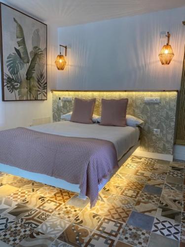 a bedroom with a large bed with purple sheets at Hacienda de las Indias, Camagüey in Granadilla de Abona