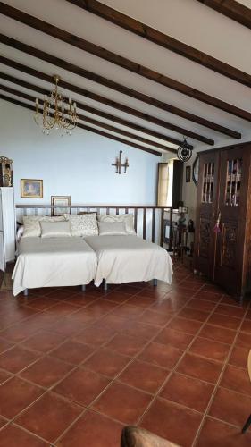 a large bedroom with two beds and a chandelier at Casa Golmar 20 in Cedeira
