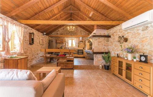 a large living room with a stone wall at Two-Bedroom Holiday Home In Jagodnja Gornja in Gornja Jagodnja
