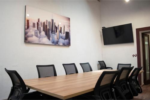 a conference room with a wooden table and chairs at Quinta Alhóndiga Galindo Hotel Boutique in Cholula