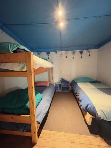 a bedroom with two bunk beds in a tent at SURFHOUSE Pichilemu in Pichilemu
