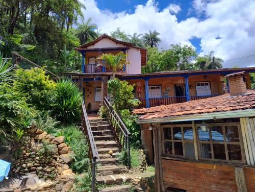 a house with a staircase leading up to it at Pousada Bosque das Borboletas in Sabará